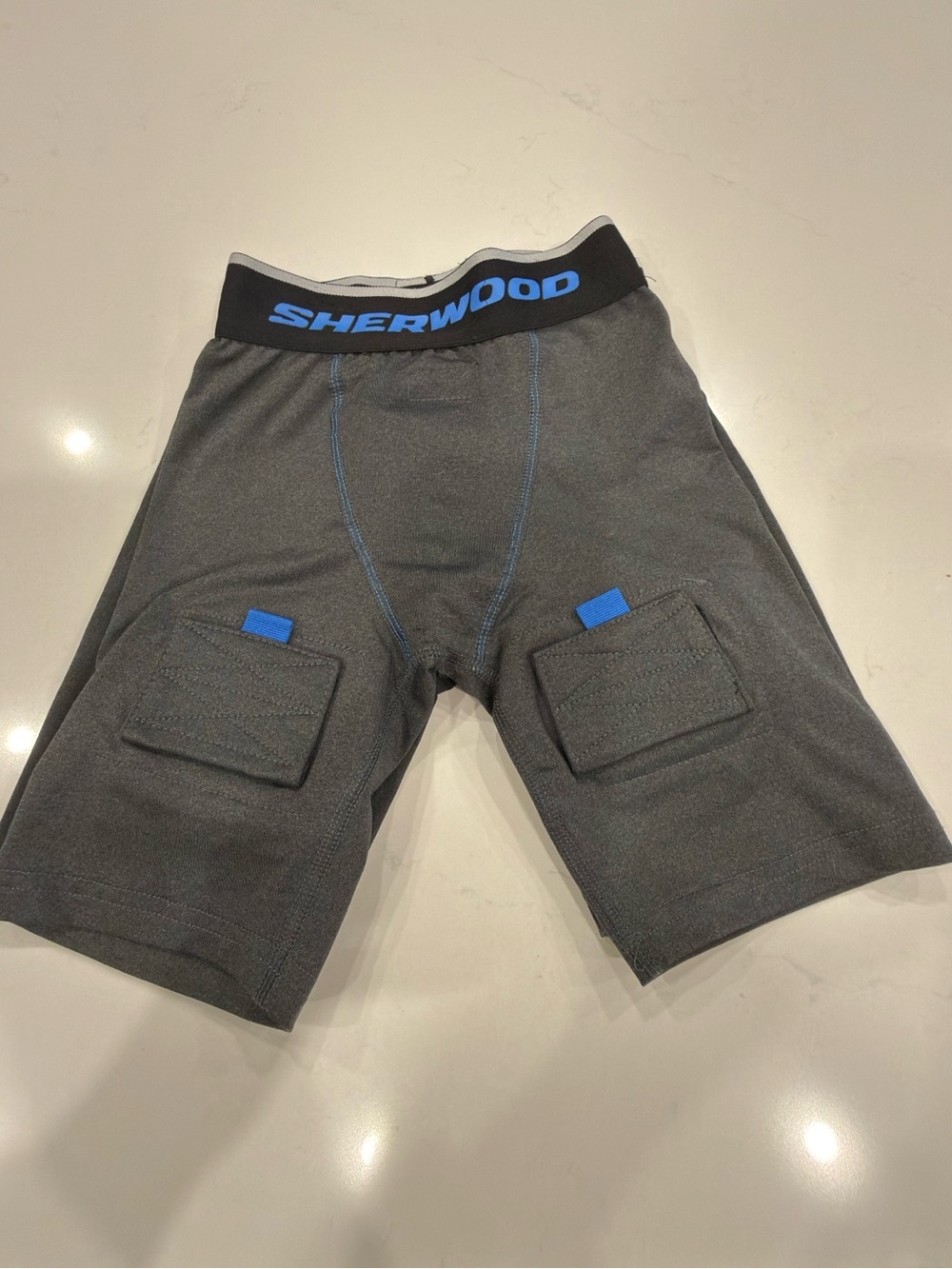 Youth Gray Athletic Hockey Compression Shorts with Blue Accents